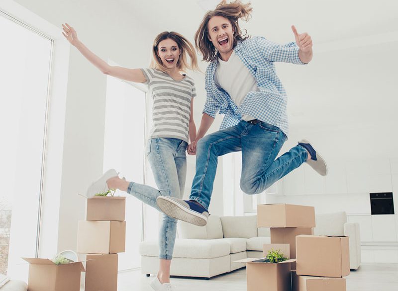 happy couple packing up their house to move