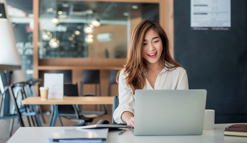 Girl on a computer applying for a loan with Uprova