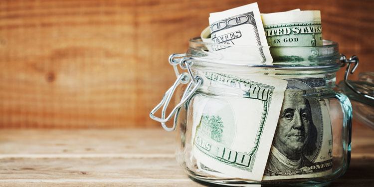 Jar of money as an emergency fund so that you have savings set aside for unexpected expenses.